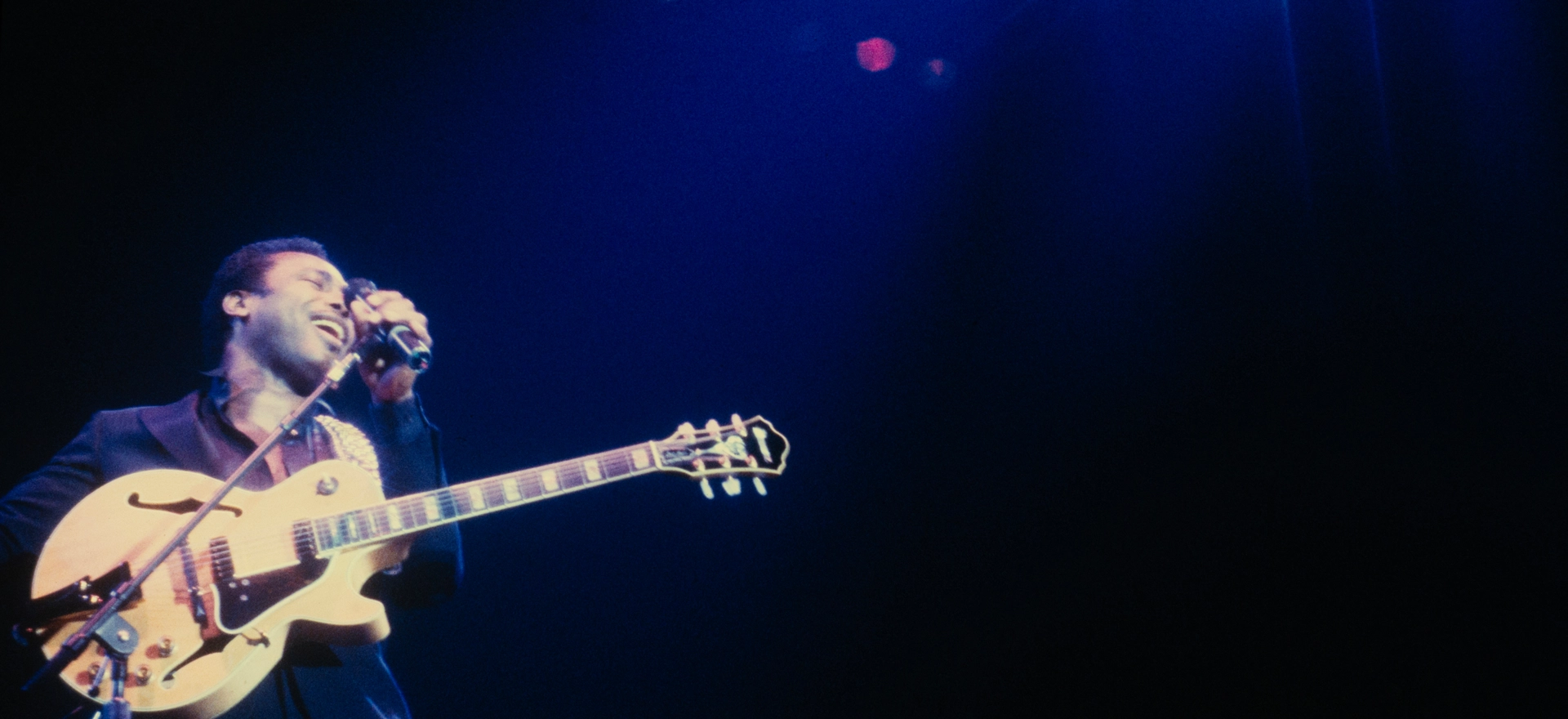 Looking up at George Benson performing live at the Astoria Theatre 1984 – atmospheric deep blue lighting